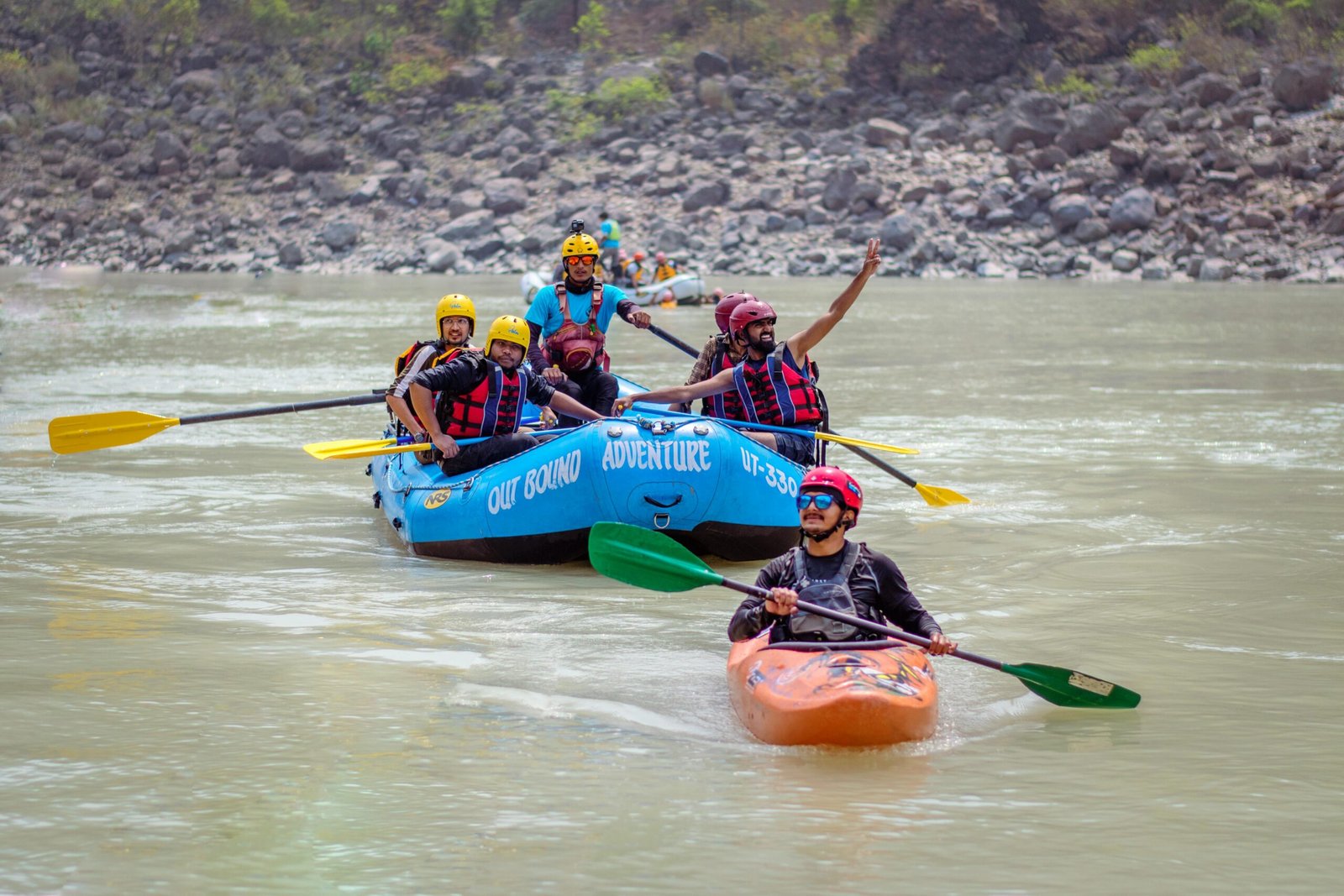 Group enjoying rafting and kayaking on the Ganges in Rishikesh, India.
